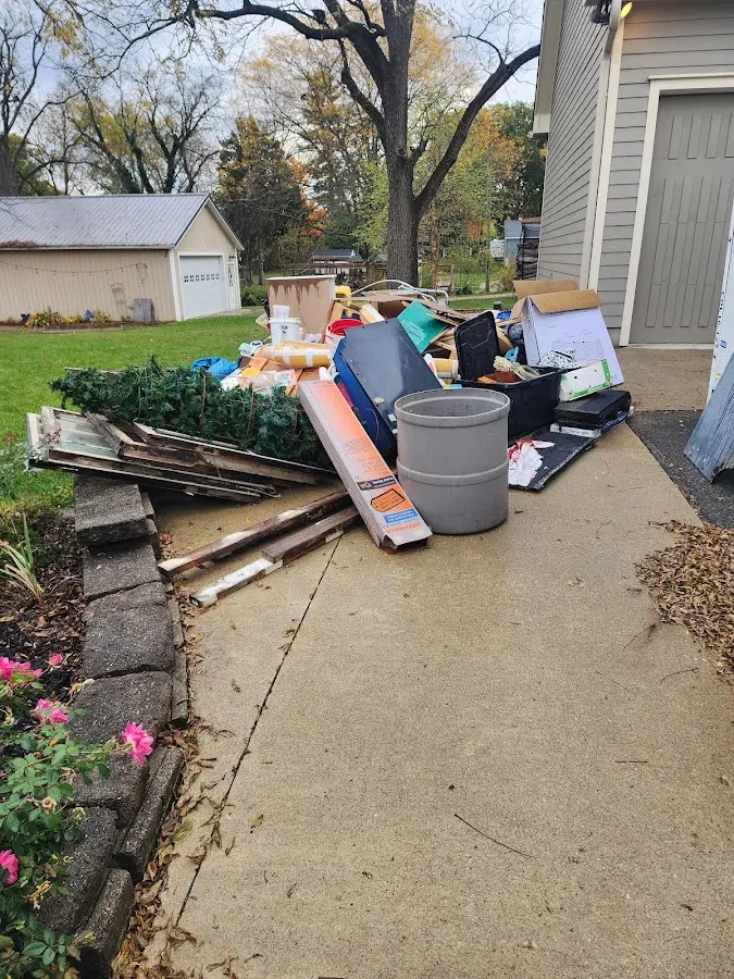 Dumpster being loaded with debris for 12 Yard Dumpster Rental in Woodhull